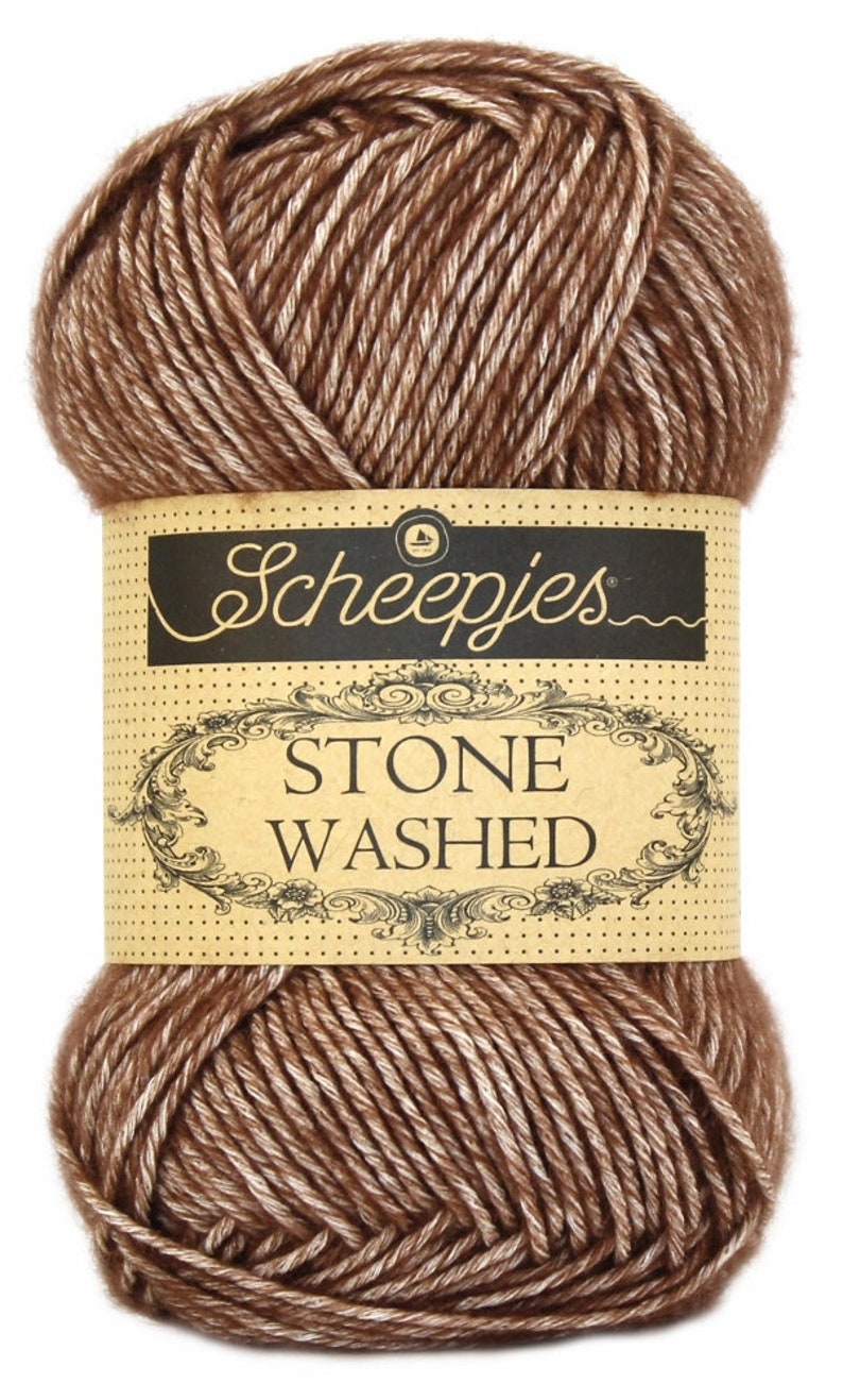 May include: A ball of brown and white yarn with a label that reads "Scheepjes Stone Washed."