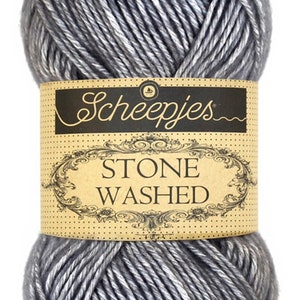 May include: A skein of gray yarn with a white sheen. The yarn is labeled "Scheepjes Stone Washed."
