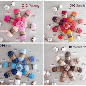 May include: Assortment of yarn skeins in various colors, including pink, red, orange, yellow, blue, brown, and white. Each skein is labeled with a number and a color name. The yarn is arranged in a circular pattern, with the labels facing outward.