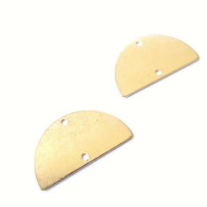 May include: Two gold-colored metal half-circle shapes with three holes each.