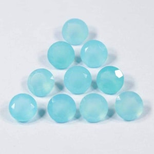 May include: Ten round, faceted, light blue chalcedony gemstones.