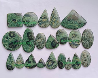 May include: Assortment of polished gemstones in various shapes, including square, round, oval, and teardrop. The stones feature a green and tan mottled pattern. Ideal for jewelry making or collecting.