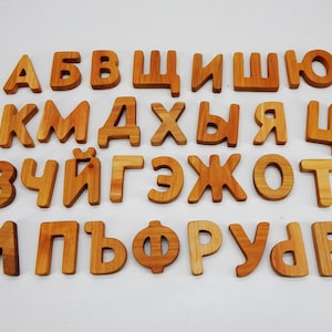 May include: Wooden alphabet blocks with the letters A, B, B, W, I, W, O, K, M, D, X, B, Y, R, U, Z, U, I, G, Z, X, O, T, A, P, B, F, O, R, U, D, E.