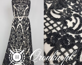 Black lace, richly decorated fabric, beads and sequins, fabric for a dress