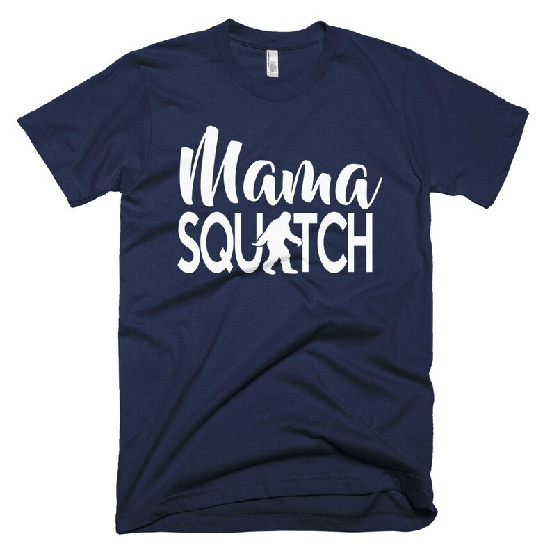 May include: A navy blue t-shirt with a white graphic that says "Mama Squatch" with a white silhouette of Bigfoot walking.