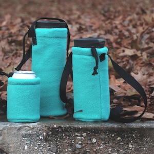 May include: Three teal fleece beverage insulators with black drawstrings. The insulators are designed to fit a variety of beverage containers, including cans and bottles.
