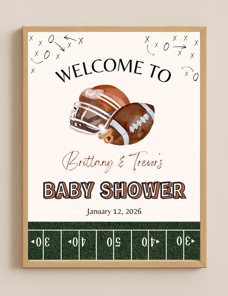 May include: A framed baby shower announcement with a football theme. The text reads "Welcome to Baby Shower" with the names "Brittany & Trevor's" and the date "January 12, 2026". The image includes a football helmet, a football, and a pacifier.
