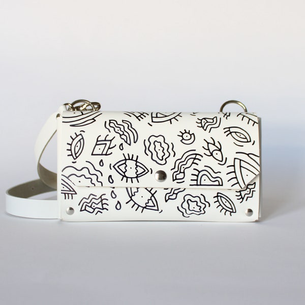 Pochette téléphone LUTI  / Cuir blanc et yeux noirs
