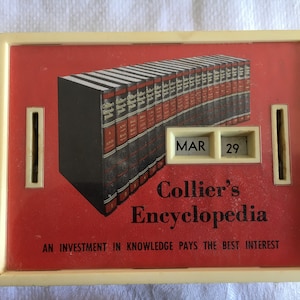 May include: A white plastic coin bank with a red background featuring a stack of books with the text "Collier's Encyclopedia" and the slogan "An investment in knowledge pays the best interest". The bank has a date display showing "MAR 29".