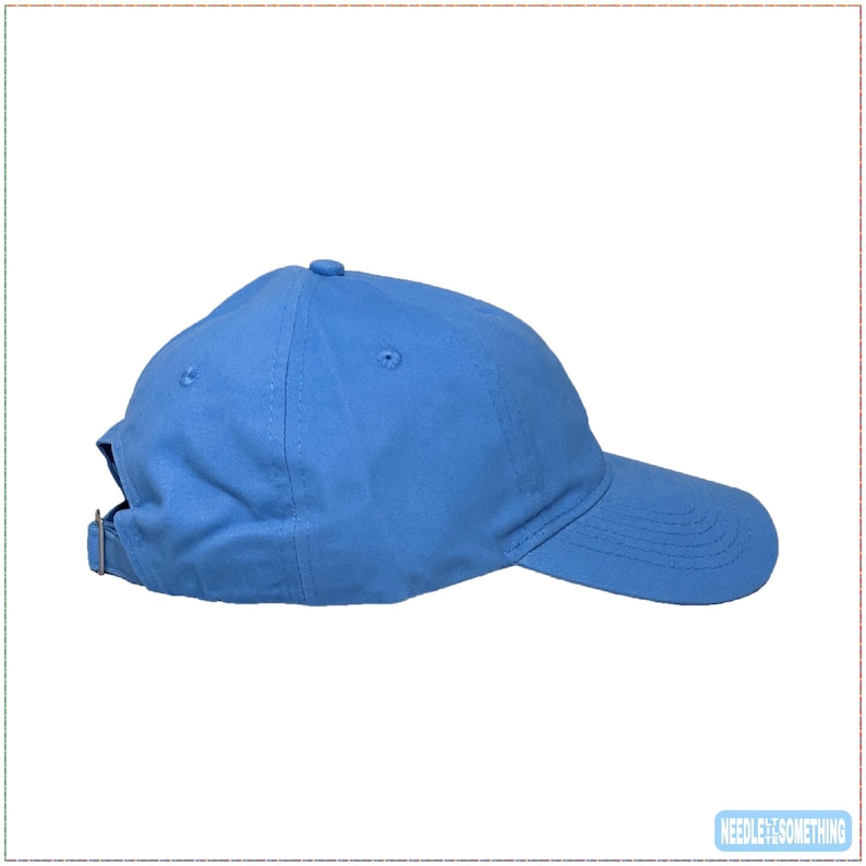 May include: A solid light blue baseball cap with a curved brim. The cap has a six-panel design with a small button on top and an adjustable metal buckle closure at the back. The hat is made of a soft, durable fabric.