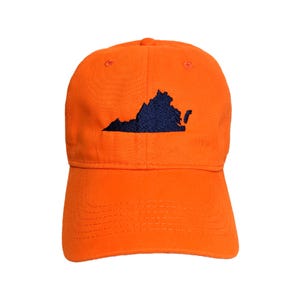 May include: Orange baseball cap with a dark blue embroidered outline of the state of Virginia on the front. The cap has a curved brim and an adjustable strap at the back. The cap is made of a soft, cotton material.