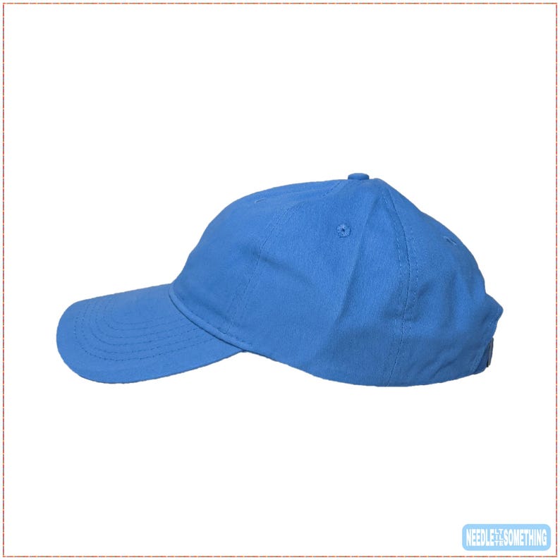 May include: A solid blue baseball cap with a curved brim. The cap is made of a soft fabric and features a six-panel design with a button on top. The hat is a vibrant shade of blue.