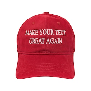May include: A bright red baseball cap featuring the white embroidered text MAKE YOUR TEXT GREAT AGAIN centered on the front panel. The cap has a structured crown, a curved brim with visible stitching, and a button at the top center of the dome.