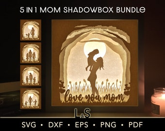 May include: A digital download of five shadowbox designs featuring a mother and child. The designs include a mother holding a child, a mother and child walking, and a mother and child standing together. The designs are perfect for creating a personalized shadowbox for a mother or grandmother.