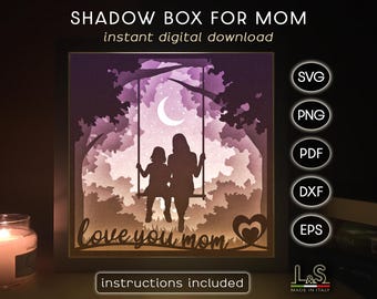 May include: A digital download of a shadow box design featuring two silhouettes of people on a swing with the text "love you mom". The design is in a purple and pink color scheme with a crescent moon in the background.