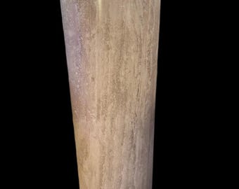May include: A beige stone column with a rounded top and base. The column has a slightly tapered design and a textured surface. The background is black. This decorative column is suitable for indoor or outdoor use.