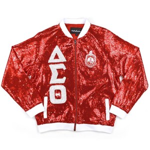 May include: Red sequined bomber jacket with white trim and a white Greek letter design. The jacket features a white embroidered crest with the letters "ΔΣΘ".