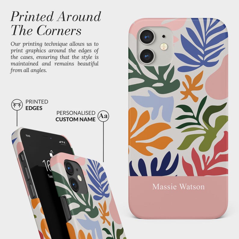 Pode incluir: Capa de telem&oacute;vel com um design floral abstrato colorido em laranja, azul, verde e rosa. A capa tem uma sec&ccedil;&atilde;o inferior rosa claro com o nome "Massie Watson" impresso. O texto "Printed Around The Corners" tamb&eacute;m &eacute; vis&iacute;vel.
