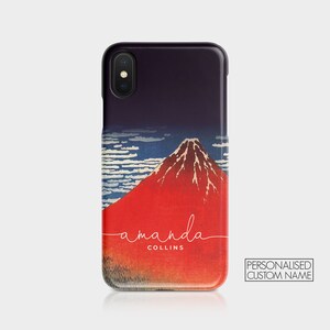 May include: A black iPhone case with a red and white image of Mount Fuji and the text "amanda COLLINS" in white cursive.