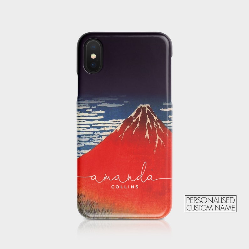May include: A black iPhone case with a red and white image of Mount Fuji and the text "amanda COLLINS" in white cursive.