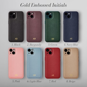 May include: Eight different colored phone cases with gold embossed initials "AS". The cases are in black, burgundy, green, navy blue, pink, light blue, red, and beige.