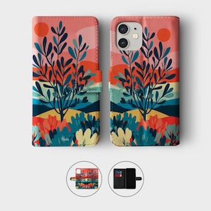 May include: A phone case with a colorful landscape design. The case features a vibrant sunset with a large orange sun, blue and yellow hills, and stylized trees. The case is open, revealing the phone inside.