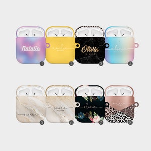 May include: Collection of personalized AirPod cases in various designs. Includes cases with names like "Natalie," "Olivia," and "Alicia." Designs feature marble, floral, leopard print, and solid colors like yellow and a gradient. Each case is designed to fit AirPods.