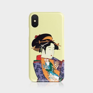 May include: A yellow phone case featuring a Japanese geisha illustration. The geisha is depicted in traditional attire with a fan, and the case has a glossy finish. The design includes shades of purple, orange, and green.