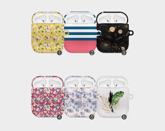 May include: Six different Airpod cases with various patterns. The cases are white with a clear front and a colourful back. The patterns include floral, stripes, planets, and leaves.