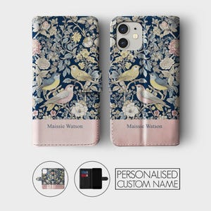 May include: A personalized phone case with a floral pattern and birds. The case is blue and pink with the name Maissie Watson printed on the bottom.