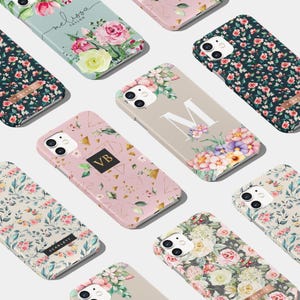 May include: A selection of phone cases with floral and geometric patterns. Cases in pink, green, and beige feature floral designs, initials, and names. Some cases have gold geometric accents.