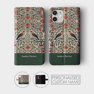 May include: A personalized phone case with a floral pattern and two birds. The case has a green leather flap with the name "Jessica Davies" printed on it.