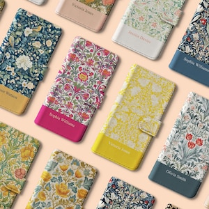 May include: A selection of floral-print phone cases in shades of blue, yellow, pink, and green. Each case has a personalised name panel. The cases are folio-style with a magnetic clasp.
