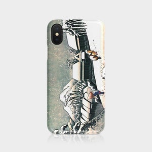 May include: A phone case featuring a Japanese woodblock print of a waterfall and figures. The design includes shades of white, gray, and brown, with a detailed depiction of the landscape and figures. The case is made of a glossy material.