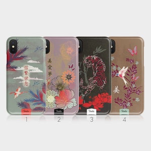May include: Four phone cases with different designs. The first case has a green background with a crane and clouds. The second case has a purple background with flowers. The third case has a black background with a tiger. The fourth case has a brown background with a bird and butterflies. The cases all have the word "Tirita" on them.