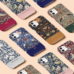 May include: A collection of personalised phone cases featuring a floral and bird design. The cases are in various colours, including pink, blue, green, and brown. Each case has a different name on the bottom, such as "Olivia Smith", "Victoria Jones", and "Maisie Watson".