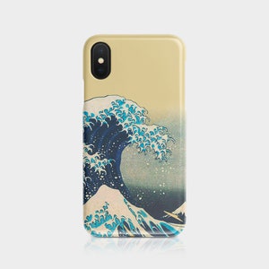 May include: A phone case featuring the iconic Japanese artwork "The Great Wave off Kanagawa." The design showcases a large, stylized wave in shades of blue and white against a cream-colored background. The case is designed to fit a smartphone.