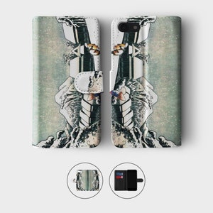 May include: A phone case with a Japanese-inspired design featuring a wave and a mountain. The case is made of leather and has a wallet flap.