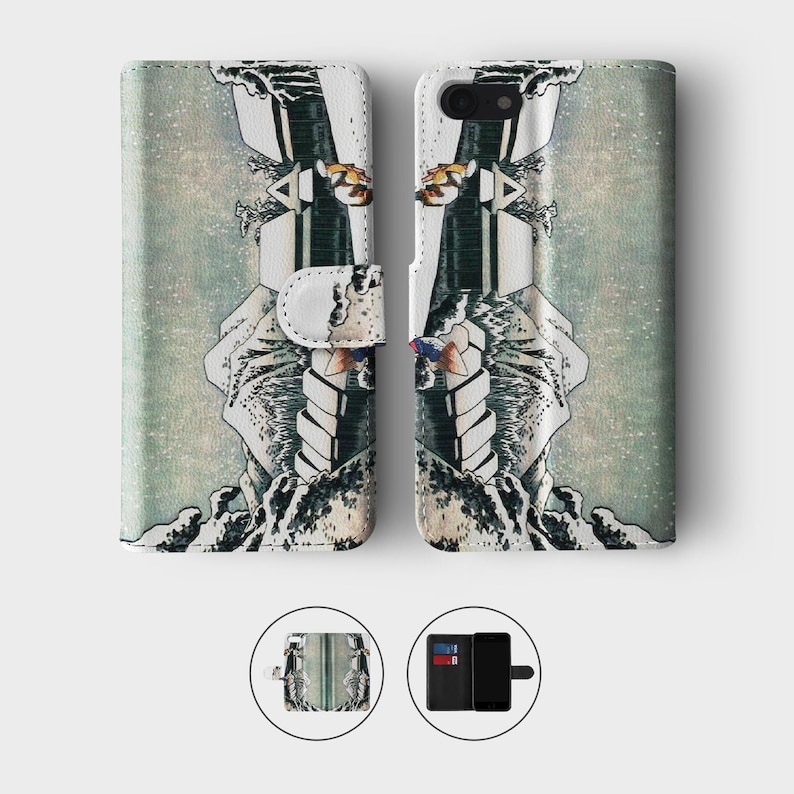 May include: A phone case with a Japanese-inspired design featuring a wave and a mountain. The case is made of leather and has a wallet flap.