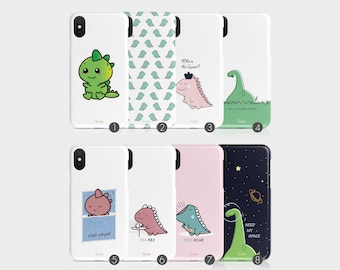 Op de afbeelding: Acht verschillende telefoonhoesjes met schattige dinosaurus illustraties. De hoesjes zijn wit, roze en blauw met groene, zwarte en witte accenten. De ontwerpen omvatten een dinosaurus met een kroon, een slapende dinosaurus, een dinosaurus die thee drinkt, een brullende dinosaurus en een dinosaurus in de ruimte.