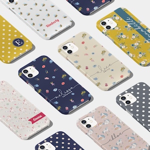 May include: Assortment of colorful phone cases with various patterns and names.  The cases feature designs like bees, polka dots, flowers, and unicorns.  The names on the cases include Kimberly, Emma, Melissa Johnson, Alice Smith, Chloe, and  Morgan.