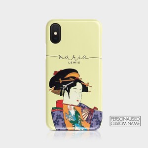 May include: A yellow iPhone case with a colorful illustration of a woman in traditional Japanese clothing. The text "maria LEWIS" is printed on the case.