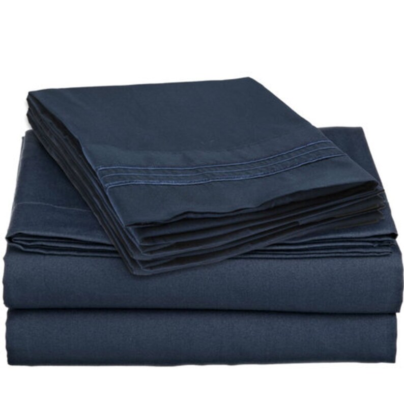 May include: A set of navy blue bed sheets with a subtle striped pattern. The sheets are folded neatly and appear to be made of a soft, comfortable material.