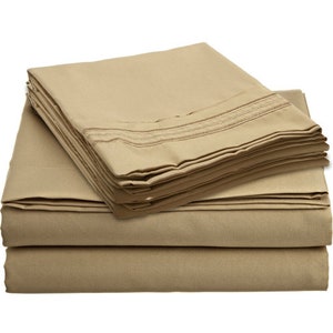 May include: A stack of beige bed sheets with a subtle striped pattern. The sheets are folded neatly and appear soft and comfortable.