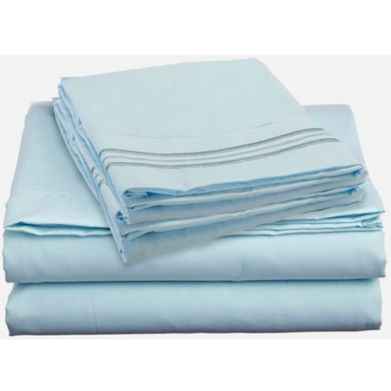 May include: A set of light blue bed sheets with a subtle striped pattern. The sheets are folded neatly and ready for use.