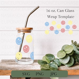 May include: A 16 ounce glass can wrap template with a design of colorful smiley faces. The template is shown on a glass can with a straw and a wooden lid. The background is a white wood panel with a green plant.