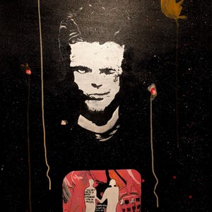 May include: Abstract painting on black canvas featuring a white silhouette of a face, a yellow monkey, and red accents. A red rectangle contains two white figures and text. The artwork has a textured, speckled appearance.