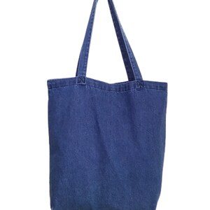 May include: A blue denim tote bag with two long handles.