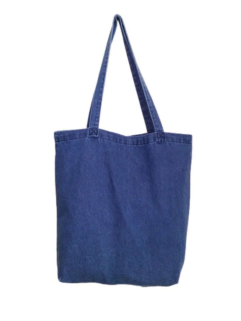 May include: A blue denim tote bag with two long handles.