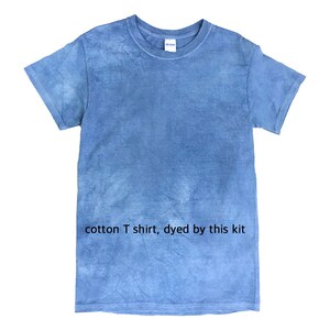 May include: A blue cotton t-shirt with a tie-dye effect. The shirt has a crew neck and short sleeves. The text "cotton T shirt, dyed by this kit" is printed on the shirt.